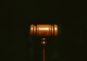 Wooden judge's gavel on a dark background, standing for a court-ordered breathalyzer requirement.