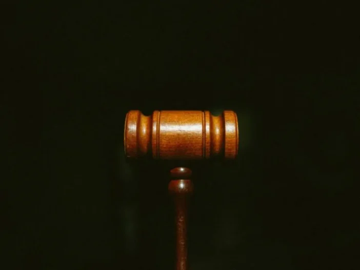 Wooden judge's gavel on a dark background, standing for a court-ordered breathalyzer requirement.