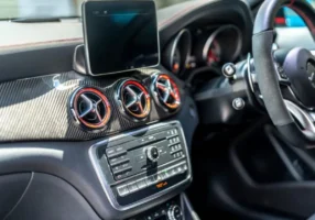 Car dashboard and steering wheel, the area where an ignition interlock device is mounted within the driver's reach.