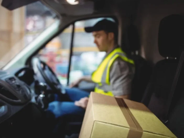 Delivery driver at the wheel of a work van, the kind of driver who may ask about an ignition interlock exemption.